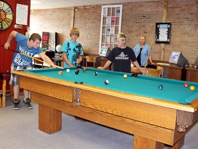Sidestreets Youth Centre in Dresden has a new permanent home offering youth 11 to 17 a place to meet new friends, play games and get help with their homework. Aaron Medd, 15, left, lines up a shot as Jordan Banman, 13, and Nathan Ellis, 12, wait their turn at the pool table. Looking on in the background is SYC boardmember Lori Ouellette.