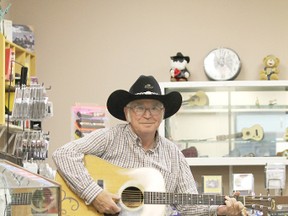 Thane Hughes poses in the new locale of Thane’s Music Stop, now in the Wetaskiwin Mall, after years of setting up shop on Main Street.