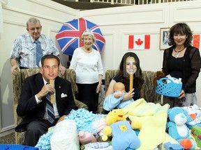 Prince William (aka Fred Peebles) and Duchess of Cambridge Kate (Stacey Davies) enjoy a baby shower in honour of the birth of their son George with the King (aka Jack Goodman) and Queen Elizabeth (aka Winifred Spencer), and present Heather Dejong, right, of Nova Vita Womens Services with baby gifts donated by the residents of Telfer Place retirement residence. Telfer Place threw the tea party and fundraiser on Aug. 9. Pianist Ross Wooldridge performed. MICHAEL PEELING/The Paris Star/QMI Agency