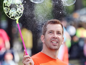 Philippe Champagne releases bubbles while playing with his kids at the ManyFest street festival in 2011. This year, organizers expect upwards of 40,000 people to come downtown starting Friday. (BRIAN DONOGH/WINNIPEG SUN FILE PHOTO)