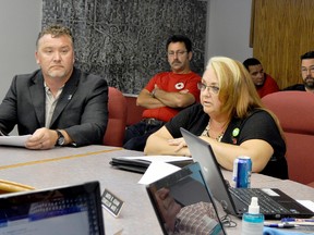 Brent Currie, left, president of the EMS Local 417, and MGEU president Michelle Gawronsky appealed to Coun. Garth Asham and other members of the Rural Municipality of Portage la Prairie council at Tuesday's council meeting. (CLARISE KLASSEN/PORTAGE DAILY GRAPHIC/QMI AGENCY)