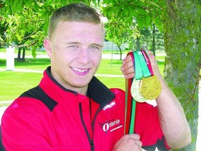 Wrestler Clayton Pye displays the gold and silver medals he won at the Canada Summer Games in Sherbrooke, Que. last week. (STEVE RICE The Beacon Herald)