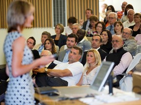 Former NHL star Eric Lindros, wearing a white T-shirt, sits in the front row listening to Lisa Fischer, director of primary care sports medicine at the Fowler Kennedy Sport Medicine Clinic, discuss clinical management of sports concussions during a symposium at Western University on Wednesday. Lindros is the honorary chairperson of See the Line, an initiative that brought together athletes, physicians, academics and parents to discuss the impact of concussions on lives, learning and sports. (DEREK RUTTAN,  The London Free Press)