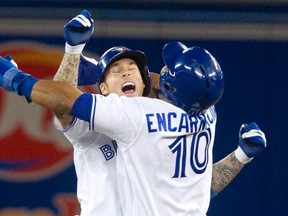 Toronto Blue Jays Brett Lawrie (L) celebrates with teammate Edwin Encarnacion after he drove in the winning run in the 10th inning of their American League MLB baseball game against the Boston Red Sox in Toronto August 14, 2013.  (REUTERS)