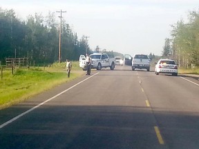 Photo courtesy Jonathan Hiscock
RCMP officers are seen on Highway 733 near Highway 49, south of Wanham on Wednesday after a Mountie was injured in an altercation.