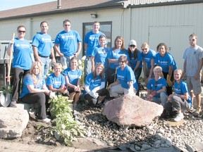 People working on beautification projects on Aug. 15 at New Beginnings paused for a photo near the newly-installed living rock fountain. First row, from left: Caroline Knight, Heather Donaghey, Kaylee Derooy, Lynnette VanLandeghem, , Mary Lynn Lister Santavy, Andrea Stass, Laurissa Polkinghorne. Back row: Charlene Thibeault, Greg Prieur, Brian Kemp, Greg Homewood, Lu Ann Smeenk, Cindy Pittuck, Alex Moskalyk, Barb Petek, Carrie Dudley-Tatsu, Zach Vanderpaelt, Tyson Carr.