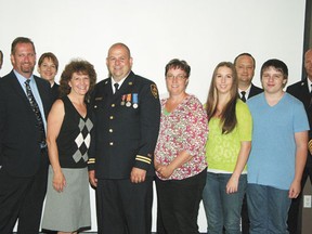 Devon fire captain Shawn O’neill (centre, with family and members of the fire department and Devon council) was honoured for earning the Fire Services Exemplary Service Medal at council on Monday, Aug. 12.