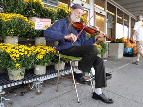 A familiar face outside Belleville's Metro grocery store, long-time busker Garrick Tyas. - JEROME LESSARD/The Intelligencer File photo