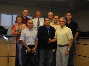 Mayor Stuart Houston (front right) shakes hands with Rotary Club president Nizar Abouchami (front centre) after council approved $23,500 in funds to an ornamental tree initiative on Monday, August 12. - April Hudson, Reporter/Examiner