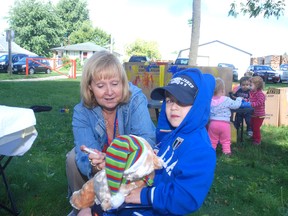 Registered nurse Wendy Jackson of Elgin-St. Thomas Public Health makes sure Nathan D'Alessandro's teddy bear gets his shots at the Tedd Bear picnic last week at Miller Park in West Lorne. Approximately 220 parents and their children, with bears, came to the annual event.