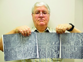 Local historian Dave Drader holds up three photos depicting a stretch of Wye Road from Highway 14 (on the left image) to Sherwood Heights (on the right). The images were taken before much of Sherwood Park was developed. Drader is working on a project to collect historical memories and artifacts related to the area. Michael Di Massa/Sherwood Park News/QMI Agency
