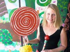 Tanya VanRooy, one of the local coordinators of the street fair that will accompany the Gentlemen of the Road Stopover in Simcoe next week, stands next to one of the backdrops that will be positioned around downtown for people to pose at with their own cameras. (SARAH DOKTOR Simcoe Reformer)