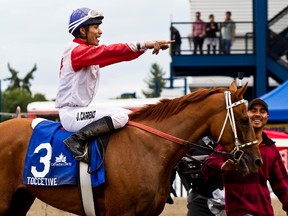 Jorge Correno rode Toccetive to victory at the 2012 Canadian Derby. Toccetive was the third locally-trained winner in a row at the Derby. (Ian Kucerak, Edmonton Sun)