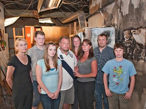 Family members and employees of The Bun Shoppe, Nancy Ainger (left), Allan Ainger Jr., Caroline Sanders, Allan Ainger, Megan Killeleagh, Tanya Killeleagh, Kennith Clarke and Andrew Ainger, stand Thursday inside the bakery, which was damaged by a fire Sunday. (Brian Thompson, The Expositor)