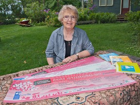 Lin Geary of Paris shows posters with her winning haiku entry that appear on Vancouver buses. (Brian Thompson, The Expositor)