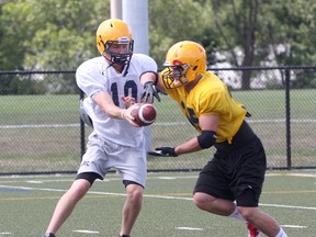 Ian MacAlpine The Whig-Standard

Queen's Golden Gaels 2012 starting quarterback Billy McPhee hands off to running back Jonah Pataki during the first day of the team's training camp at Queen's West Campus.