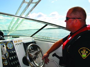 Constable Mike Barclay of the Kenora OPP Marine Unit cruises through the water under sunny skies, Aug. 14. The Kenora OPP Marine Unit does day time and night time patrols on Lake of the Woods and many surrounding lakes, extending all the way from the Manitoba border up to Vermilion Bay.