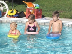 Alyson Bierling, 16, started A.B. Swim School in the backyard of her Chatham home through the summer company program offered by Chatham-Kent's Economic Development Services. Here, she gives lessons to the Kloostra children Katelyn, 3, Addison, 5, and Dylan, 7. ELLWOOD SHREVE/ THE CHATHAM DAILY NEWS/ QMI AGENCY