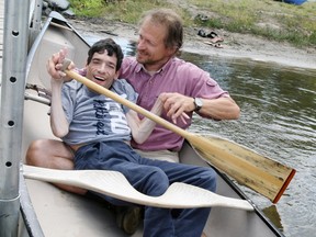 Bryan Ceppetelli's first time in a canoe, with the help of Kevin Palmer, a personal support worker with L'Arche, an organization assisting people with intellectual disabilities, during the fifth annual Up the Creek without a Paddle fundraiser for North Bay's PADDLE program Providing Adults with Developmental Disabilities Lifelong Experiences, Friday at Olmsted Beach. (MARIA CALABRESE The Nugget)