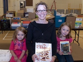 TAYLOR WEAVER HIGH RIVER TIMES/QMI AGENCY
Susan Curran and her daughters Kennedi (L) and Kayleigh (R) donated books to Spitzee school last week. Curran is a former student of the school.