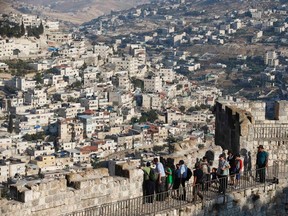 Children walk atop a wall surrounding Jerusalem?s Old City, a 10-minute drive from where negotiators will sit down on Wednesday to resume long-stalled Middle East peace talks, Among Palestinians there is widespread pessimism. (Ronen Zvulun Reuters)