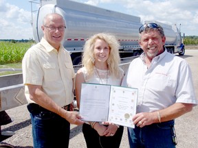 Lambton-Kent-Middlesex MP Bev Shipley, left, presents a certificate to Amelia and Denis Marcus of Comptank Corp. in Bothwell, a sister company of Harold Marcus Ltd., on the completion of the 700th tank trailer used to haul corrosive material on the highway. BOB BOUGHNER/ THE CHATHAM DAILY NEWS/ QMI AGENCY