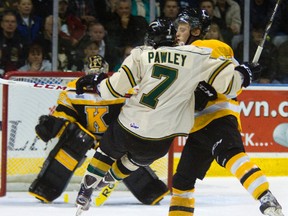 Kingston Frontenacs defenceman Matt Watson sends the London Knights’ Corey Pawley flying with a bodycheck during an Ontario Hockey League game in Watson’s hometown of London on Dec. 16, 2012. It was one of eight games Watson played for Kingston last season. (Mike Hensen/QMI Agency)