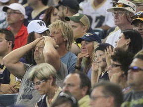 CFL Blue Bombers fans watch their team lose to the Hamilton Tiger-Cats  at Investors Group Field in Winnipeg.  Friday, August 16, 2013.
