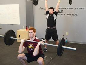 Chris Minns, left, and Jordan Larson plug away at the lifting portion of the Pembroke Lumber Kings fitness test that kicked of this year's training camp on Friday morning at LEAP High Performance in Pembroke. For more community photos please visit our website photo gallery at www.thedailyobserver.ca.