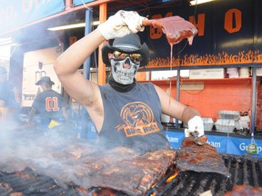 Sudbury Star file photo
Brian Caza of Boss Hog's BBQ Rib Team sauces some ribs at last year's Ribfest. This year, six teams will compete for top honours in four categories, including best chicken, best sauce, best ribs and the people's choice award.