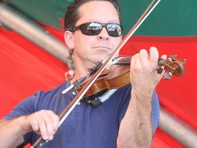 Louise Schryer draws his bow while playing a fiddle tune at the Sturgeon Falls Step Dance and Fiddle Festival, Saturday, entertaining country music lovers in the trailer park. He was one of the judges for the competition finals Saturday night.
