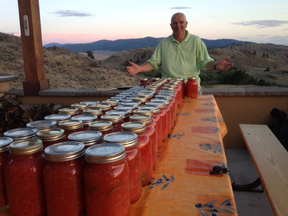 Gary Goulet shows off 180 pounds of Osoyoos tomatoes canned at the Hooper Hilton. The lovely ladies who did all the work are not pictured. (DANNY HOOPER PHOTO)