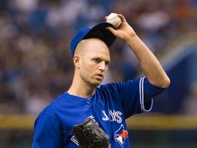 Toronto Blue Jays pitcher J.A. Happ adjusts his cap after giving up a run to the Tampa Bay Rays during the fourth inning of their MLB American League baseball game in St. Petersburg, Florida August 17, 2013. (REUTERS/Scott Audette)