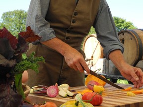 Bob Blackadder serves up brandywine tomatoes and candy cane beets - veggies of every colour of the rainbow and crisp interesting flavours to brighten up a salad - at the Loucks farm kitchen garden at Upper Canada Village in Morrisburg, Ont., where the Food Lovers' event was held Aug. 17 and 18, 2013. KATHRYN BURNHAM/CORNWALL STANDARD-FREEHOLDER/QMI AGENCY