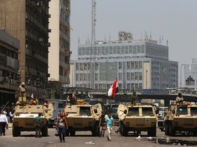 Soldiers stand guard on an armoured personnel carrier positioned outside Ramses Square, near al-Fath mosque in Cairo August 17, 2013.  REUTERS/Youssef Boudlal