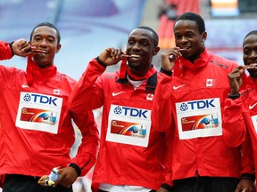 Canada's 4x100-metre relay team Dontae Richards-Kwok (left to right), Gavin Smellie, Aaron Brown and Justyn Warner pose with their bronze medals at the 2013 IAAF World Championships in Moscow. (GRIGORY DUKOR/Reuters)