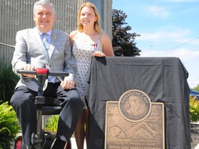 Ontario Lieutenant-Governor David Onley helped Annaleise Carr unveil a plaque in her honour at the Annaleise Carr Aquatic Centre in Simcoe on Saturday. Carr, a Norfolk County resident, is the youngest person to swim across Lake Ontario. She completed the feat one year ago, on August 19, 2012. (DANIEL R. PEARCE Simcoe Reformer)