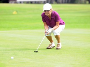 Logan Clow/Daily Herald-Tribune
Margaret Abbott-Brown lines up her putt at The Grande Prairie Golf and Country Club 45th Annual Ladies’ Open Golf Tournament, sponsored by Mirage Holistic Spa on Sunday morning. See Tuesday’s DHT for full tourney results.