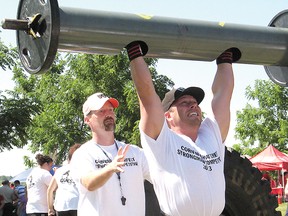 Todd Hambleton photo
Greg van Loenen, competing in the Waterfest Strongman Competition, gets a spot from organizer Greg Critch, during the 190-lb. log press for the heavyweight men’s division (211 lbs. and over).