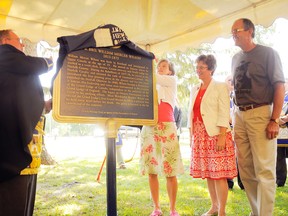 Donald Campbell (left), Grand Master of the Ontario Masons, unveiled a plaque honouring William Mercer Wilson, the founding member of the organization, at a ceremony at the St. John's Anglican Church south of Simcoe on Sunday. Campbell was helped by (left to right): Melanie Hare, a member of the board of directors of the Ontario Heritage Trust; Haldimand-Norfolk MP Diane Finley; and Norfolk County Deputy Mayor Jim Oliver. (DANIEL R. PEARCE Simcoe Reformer)