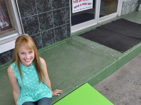 Taylor Bardell, pictured outside Four Seasons Sports Shop last Thursday, is on a mission to build free portable ramps, like the one she built for Four Seasons, for city buildings lacking an accessible entrance. Bardell hope her Ramp Project campaign will be supported by the local student community, city officials and local businesses.