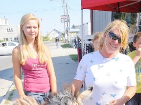 Virginia Nixon (right) of Fisherville, Ont., and her daughter Sarah were on Main Street in Port Dover Friday afternoon with their six-week-old zebra “Roy.”   (DANIEL R. PEARCE Simcoe Reformer)