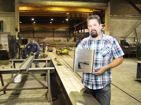 Giovanni Carniel, of C&A Steel in Sudbury, ON., holds a CISC award of excellence in engineering the company received. JOHN LAPPA/THE SUDBURY STAR/QMI AGENCY
