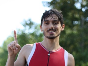 Adan Fortais gives the No. 1 sign after winning the Olympic Triathlon race on Saturday.