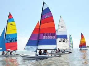 Competitors in the 19th annual Hullraisers head out into Lake Erie for the first afternoon race Sunday. The day-long event focuses on friendly competition matched with a beach party atmosphere on land for the spectators. (Diana Martin, Daily News)