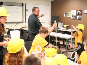 Drayton Valley/Brazeau County Fire Services Captain Will Gueth shows participants in last week's firefighters camp some know-tying skills. The four day camp was full of activities for close to 30 children who took part.