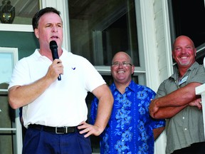Leeds-Grenville MP Gord Brown raises a smile from MPP Steve Clark and Rob Horton, president of the provincial Progressive Conservative Riding Association at Saturday's Afternoon in the Islands fundraiser for the provincial wing. (NICK GARDINER/The Recorder and Times)