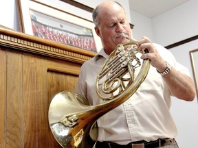 Vaughn Pugh, a Chatham lawyer, showed off some of his musical talent with his premier instrument, the French horn, at his Wellington Street law office, on Monday August 19, 2013. Pugh has been conductor and bandmaster for the Chatham Concert Band for the last 30 years. (KIRK DICKINSON, For the Daily News)