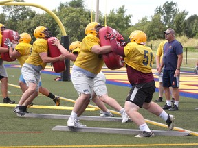 Queen's Golden Gaels head coach pat Sheahan watches the offensive line go through a drill during the first day of the team's training camp at Queen's West Campus. (IAN MACALPINE - QMI AGENCY)
