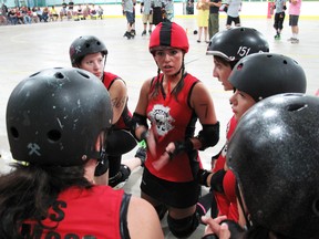 The Headstone Honeys take a moment to strategize during Saturday evening's game against the Ring Leader Roller Girls at the BDO Centre. (Svjetlana Mlinarevic/Portage Daily Graphic/QMI Agency)